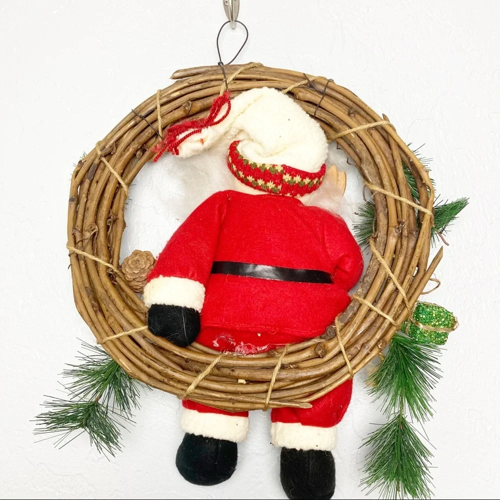Christmas wreath with stuffed Santa Claus
